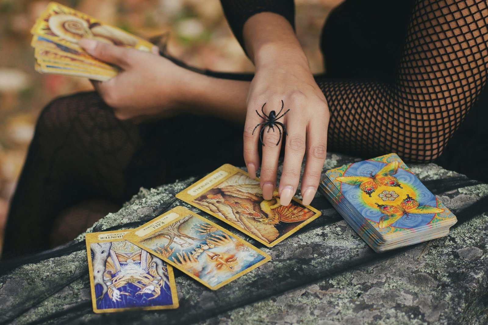 A person interpreting tarot cards, with a focus on their thoughtful expression and the cards laid out.