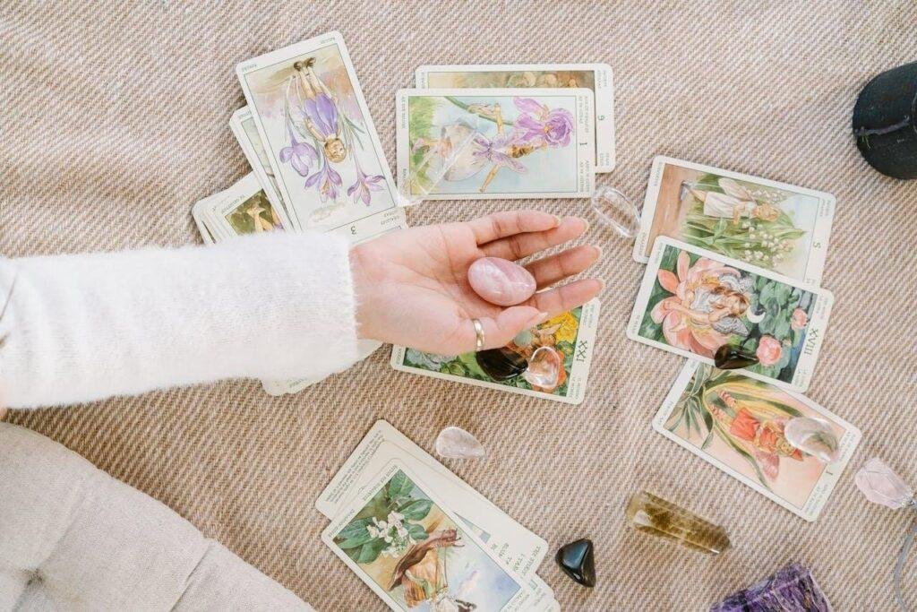 An assortment of tarot cards laid out on a table, showcasing some reversed cards.